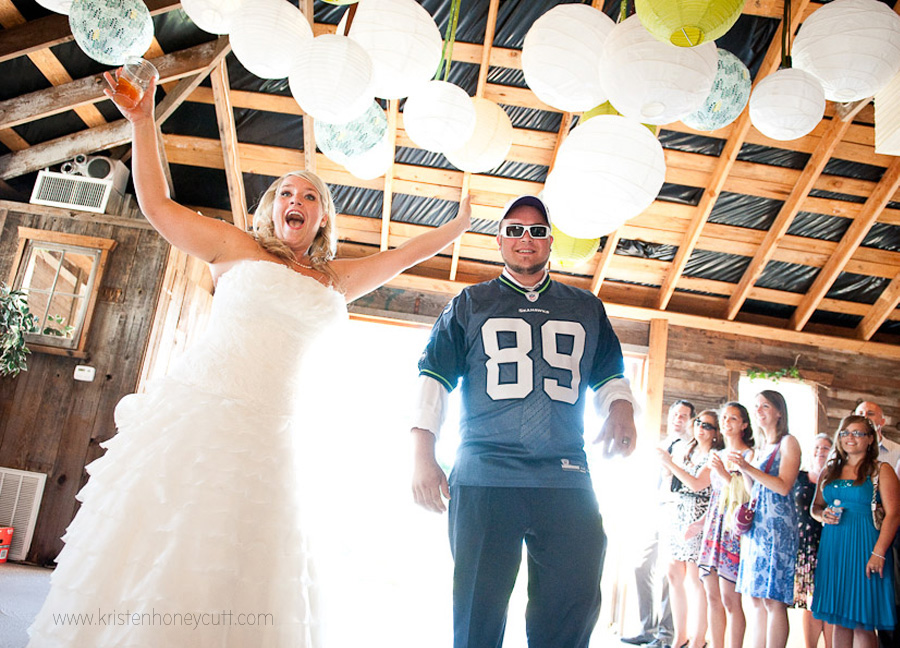 the groom wore a seahawks jersey as they entered their reception