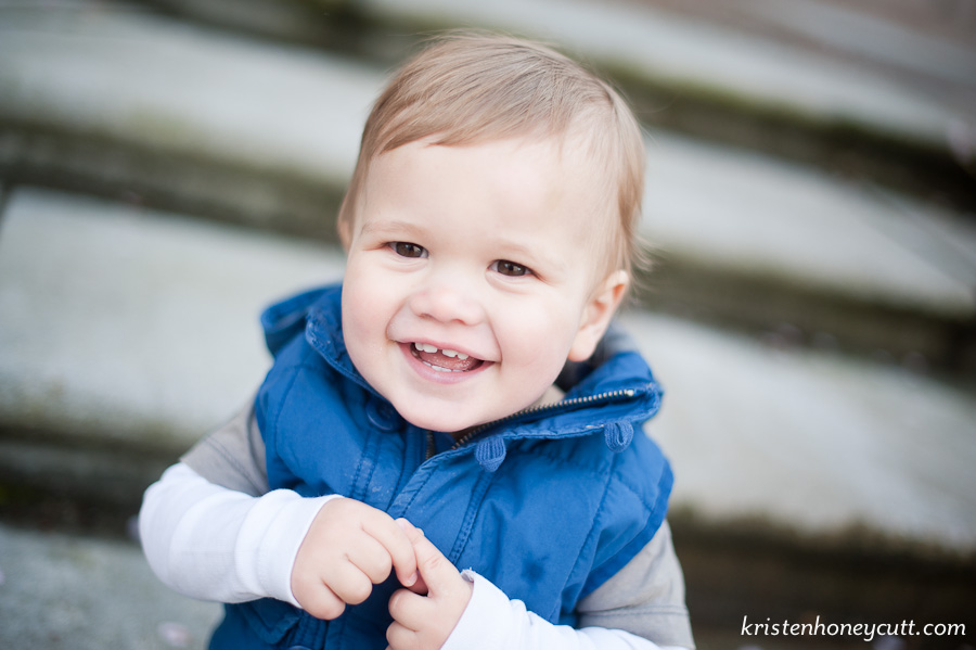 One year old boy smiles for his birthday portraits.