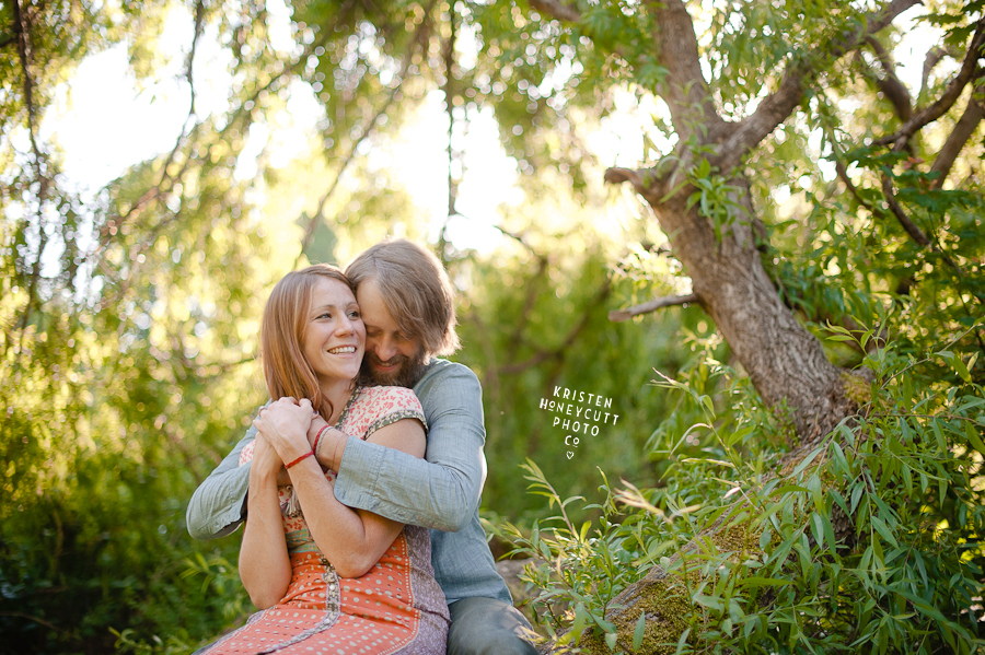 engaged couple snuggle up in a tree at seattle's arboretum for their engagement session