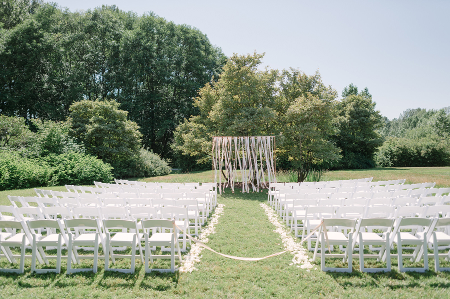 Garden wedding with a bohemian ceremony backdrop