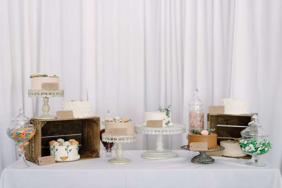 Beautiful dessert table at Seattle wedding reception with multiple cakes and different flavors
