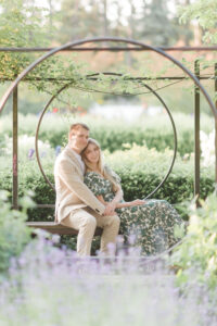 couple sitting and embracing with lavender in the foreground